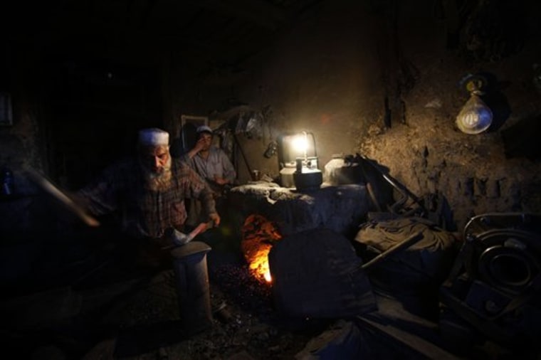Habib Ullaha an Afghan iron smith works inside his shop in Kabul, Afghanistan, on April 19. Afghanistan consumes less energy per person than any other country in the world, even after years of reconstruction efforts, according to data compiled by the U.S. government.